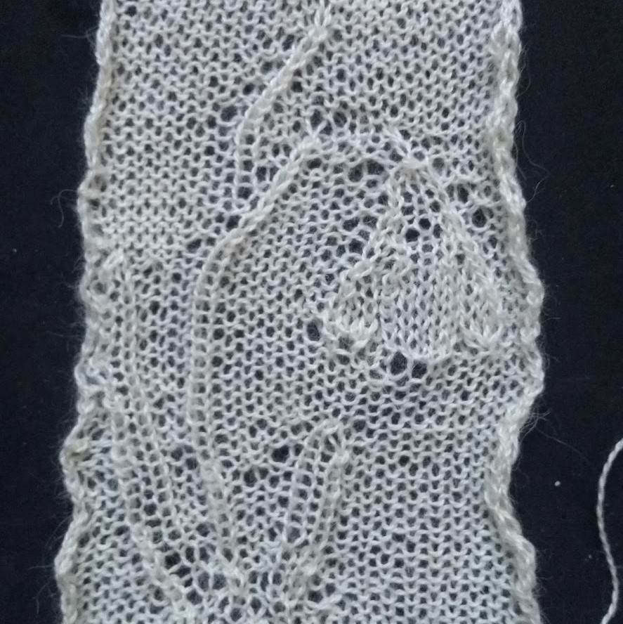 handknitted swatch of knitted lace showing snowdrop flower and leaves