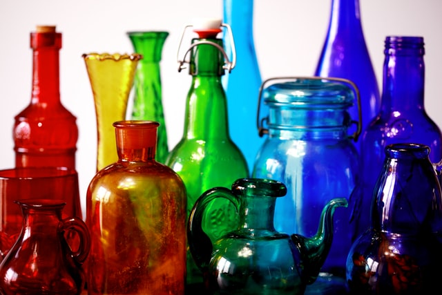 a collection of glass bottles in rainbow colours